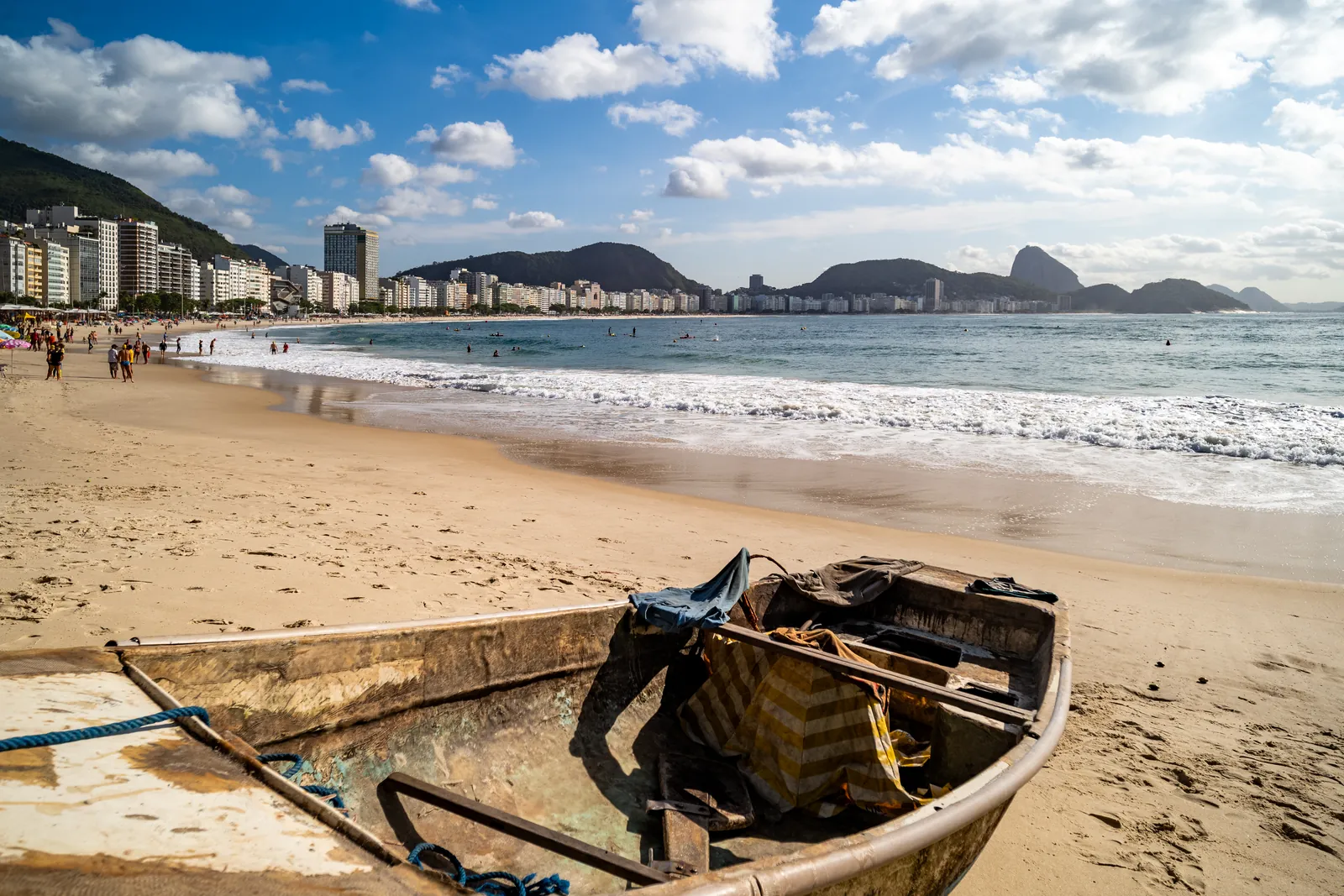 A fishing boat on Copacabana sand, the Sugarloaf beyond